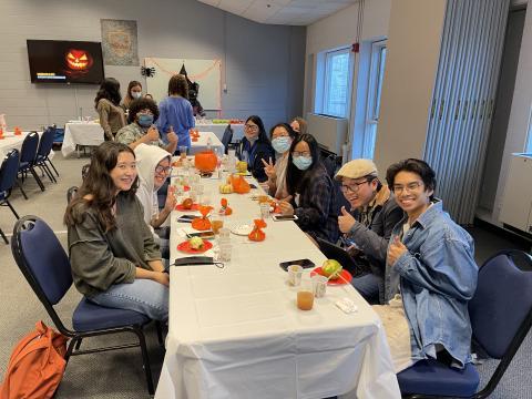 CONNECT students participating in a pumpkin decorating social