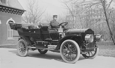 antique car with chauffeur